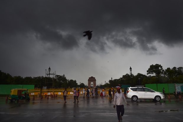 Monsoon clouds gather over India Gate in New Delhi on Saturday. (PTI)