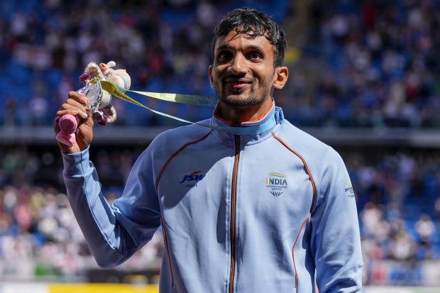 Men's triple jump silver medalist Abdulla Aboobacker Narangolintevida of India gestures on the podium during the athletics in the Alexander Stadium at the Commonwealth Games in Birmingham, England. (AP Photo)