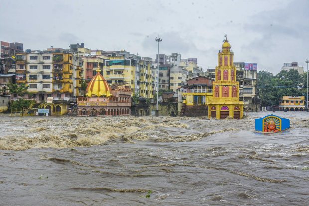 The residents of Nashik measure the intensity of flooding by watching the water level around the Dutondya Maruti (two-headed Hanuman) idol situated on the river bed. (PTI Photo)