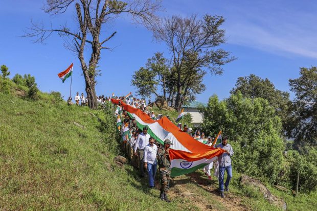 Indian Army personnel with locals participate in a 'Tiranga Yatra' ahead of the 75th Independence Day, near Line of Control (LoC) at Mendhar sector in Poonch. (PTI Photo)