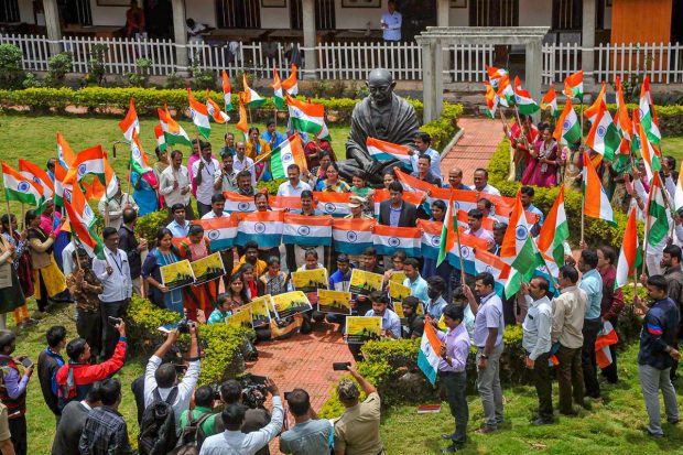 Employees of District Collectorate receive national flags to post on building and their houses as part of Har Ghar Tiranga campaign, in Chikmagalur. (PTI Photo)