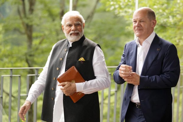 German Chancellor Olaf Scholz walks with PM Narendra Modi prior to a meeting on the sidelines of the G7 summit at Castle Elmau in Kruen, near Garmisch-Partenkirchen, Germany. (AP Photo)