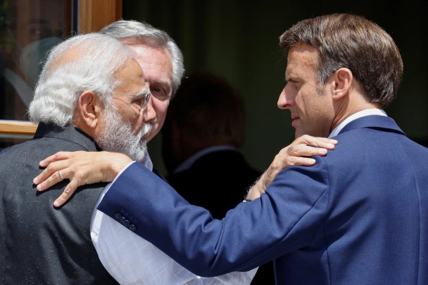 Argentina's President Alberto Fernandez looks on as Prime Minister Narendra Modi and France's President Emmanuel Macron greet each other as they arrive to attend the outreach program during the G7 leaders' summit at the Bavarian resort of Schloss Elmau castle, near Garmisch-Partenkirchen, Germany. (Reuters Photo)