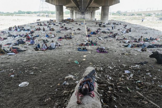 Homeless people rest under a bridge near the Yamuna River on a hot summer day, in New Delhi. (PTI Photo)