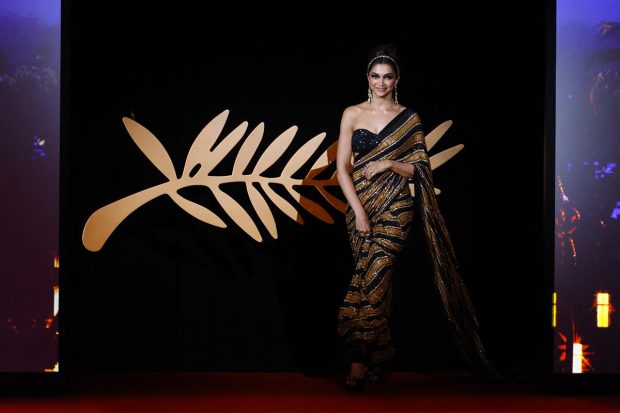 Deepika Padukone, who serves as a jury member for 75th edition of the film gala, turned up at the Cannes red carpet in a black and golden Sabyasachi sari with matching jewellery from the ace designer's Aakash Tara collection. (Reuters Photo)