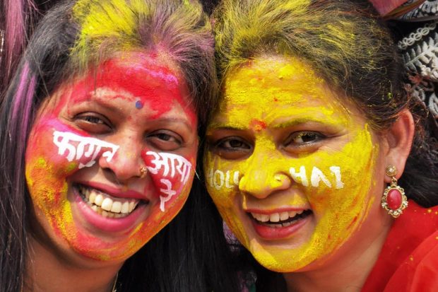 School teachers pose for photos, after playing with colours ahead of the upcoming festival of 'Holi', at a school, in Moradabad. (PTI Photo)