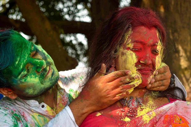 People play with colours during celebrations of the upcoming 'Basant Utsav', at Maidan in Kolkata.(PTI Photo)