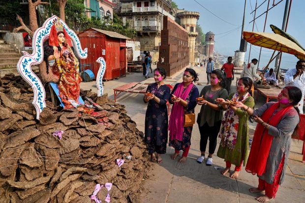 Women pray during 'Holika Dahan' on the eve of Holi, the Festival of Colours, in Varanasi. (PTI Photo)