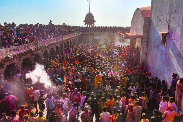 People celebrate Holi at Nandgaon, in Mathura. (PTI Photo)