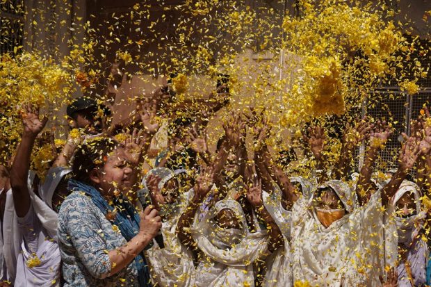 Widows play with colour in celebration of 'Holi' during a function organised by Sulabh Hope Foundation at Gopinath Temple, in Vrindavan near Mathura. (PTI Photo)