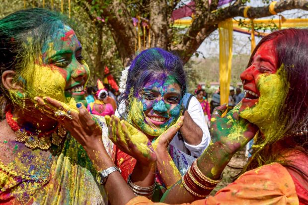 Women play with colours during celebrations of the upcoming 'Basant Utsav', at Maidan in Kolkata. (PTI Photo)