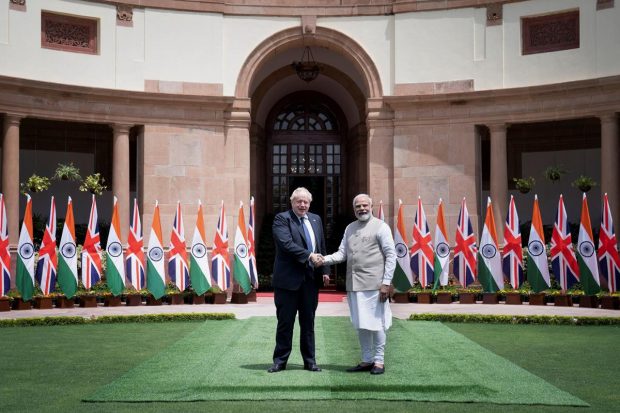 British Prime Minister Boris Johnson and PM Narendra Modi shake hands before their meeting at the Hyderabad House in New Delhi. (Reuters Photo)