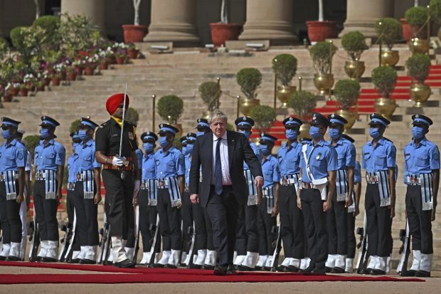 British Prime Minister Boris Johnson inspects a guard of honor during his ceremonial reception at Rashtrapati Bhavan in New Delhi. (AP Photo)