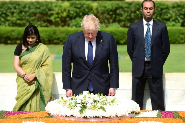 UK Prime Minister Boris Johnson pays tribute to Mahatma Gandhi at Rajghat, in New Delhi. (PTI Photo)