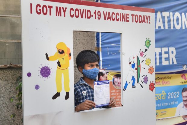 A student of the age group of 12-14 years, shows his vaccination certificate after getting administered a dose of Covid-19 vaccine at a vaccination centre, in New Delhi. (PTI Photo)