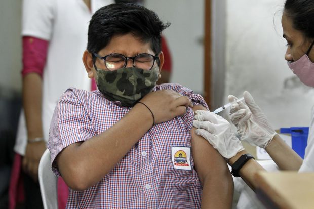 A healthcare worker administers a dose of the Covid-19 preventive vaccine to a student in the age group of 12 to 14 years, in Ahmedabad. (PTI Photo)