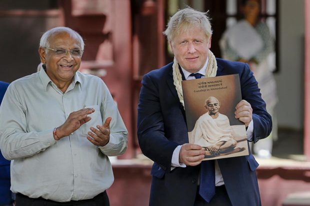 UK PM being presented a memento as Gujarat Chief Minister Bhupendra Patel looks on, during his visit to the Sabarmati Gandhi Ashram, in Ahmedabad. (PTI Photo)