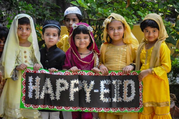 Young Muslim devotees wish 'Happy Eid', on the eve of Eid al-Fitr, in Moradabad. (PTI Photo)