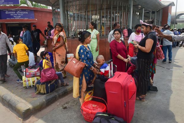 Passengers stranded at New Delhi Railway Station due to a strike by auto and taxi unions, in New Delhi. (PTI Photo)