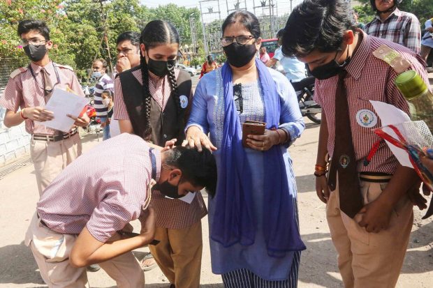 Bhopal: A student seeks blessings of his teacher before appearing for the CBSE Exams for Term 2, at an examination centre, in Bhopal. (PTI Photo)