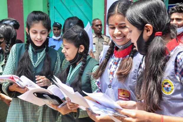 Moradabad: Students of class 10th interact with each other after appearing for the first exam of CBSE's Term 2, outside an examination centre, in Moradabad. (PTI Photo)