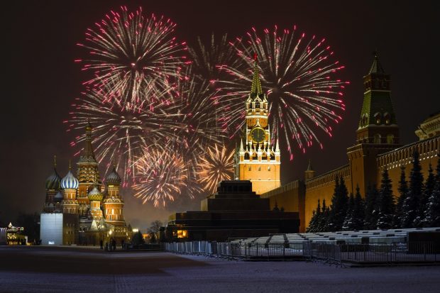 Fireworks explode over the the St. Basil's Cathedral and the Kremlin with the Spasskaya Tower on empty Red Square due to pandemic restrictions during New Year's celebrations, in Moscow, Russia. (AP/PTI Photo)