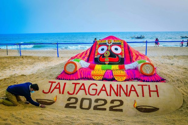 Sand artist Sudarshan Pattnaik creates a sand sculpture on the eve of New Year, in Puri (PTI Photo)