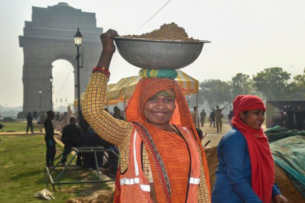 Women work at India Gate Lawn on International Women's Day 2022, in New Delhi. (PTI Photo)