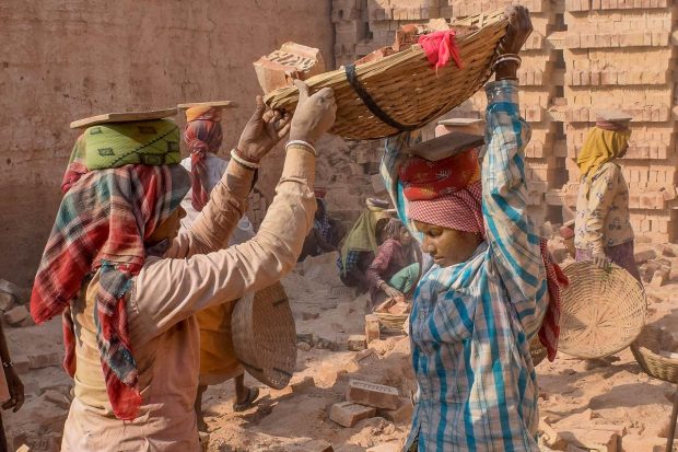 Women work at a brick kiln on International Women's Day, in Nadia. (PTI Photo)