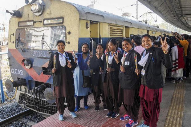 Women Ticket Collectors deployed on Lohardaga Special passenger train flash victory sign on International Women's Day, in Ranchi. (PTI Photo)